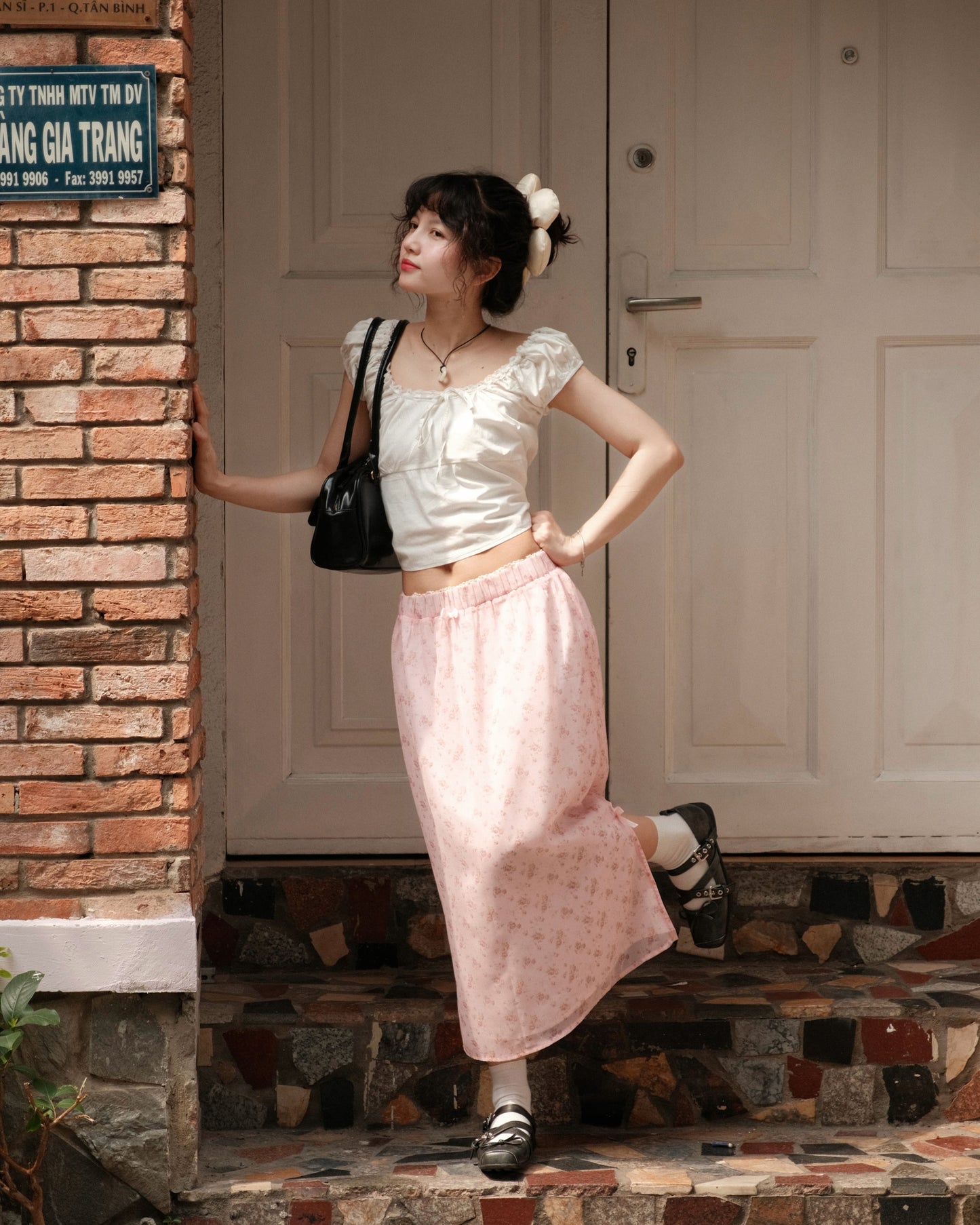 girl wearing cute pink skirt posing on stairs with one leg kicked up