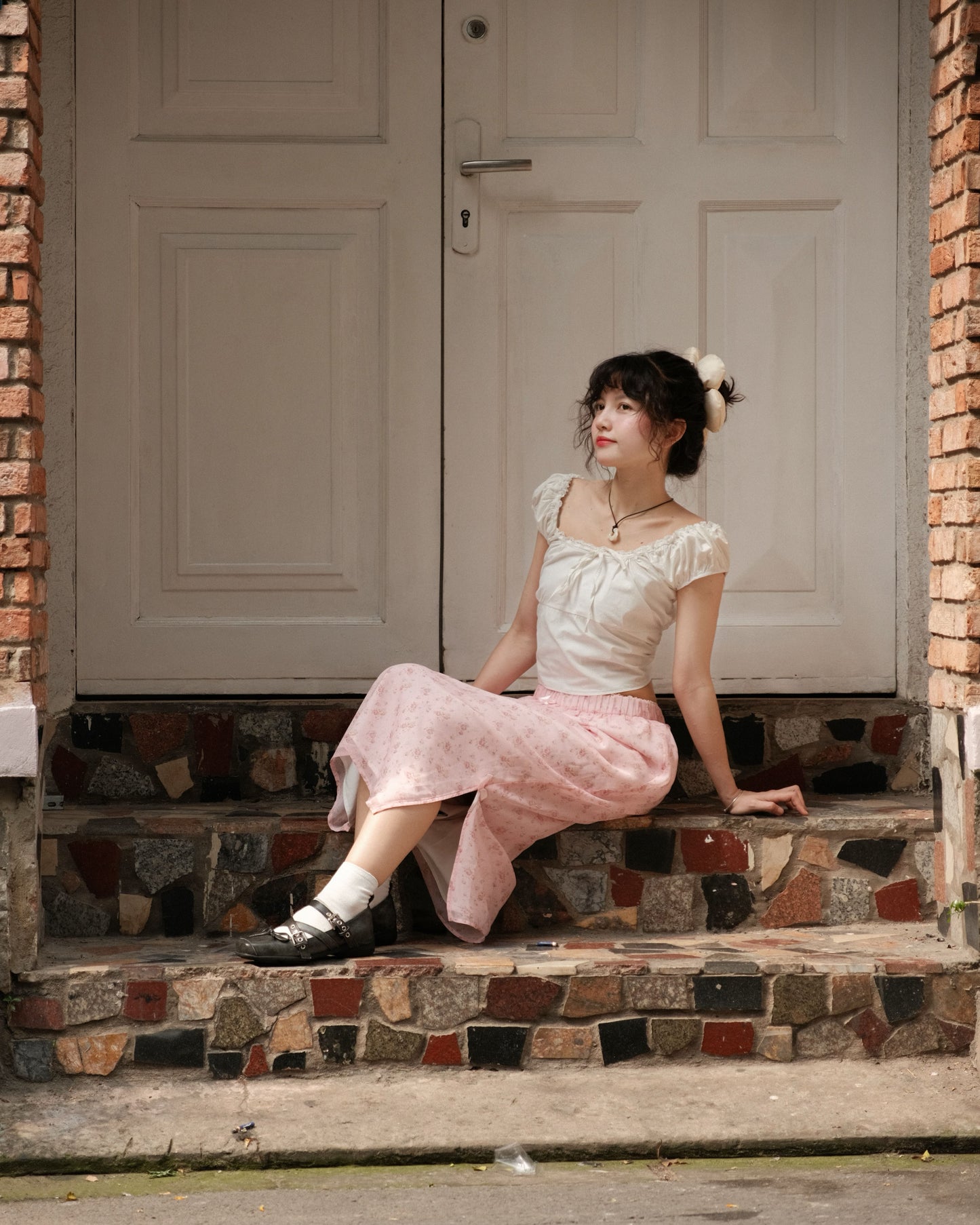 girl wearing cute pink skirt sitting on stairs